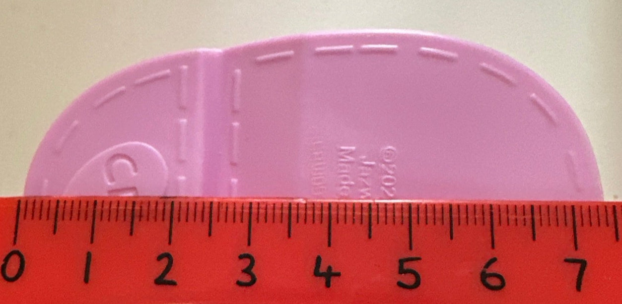 Measurement of a shoe insole with a ruler showing dimensions.